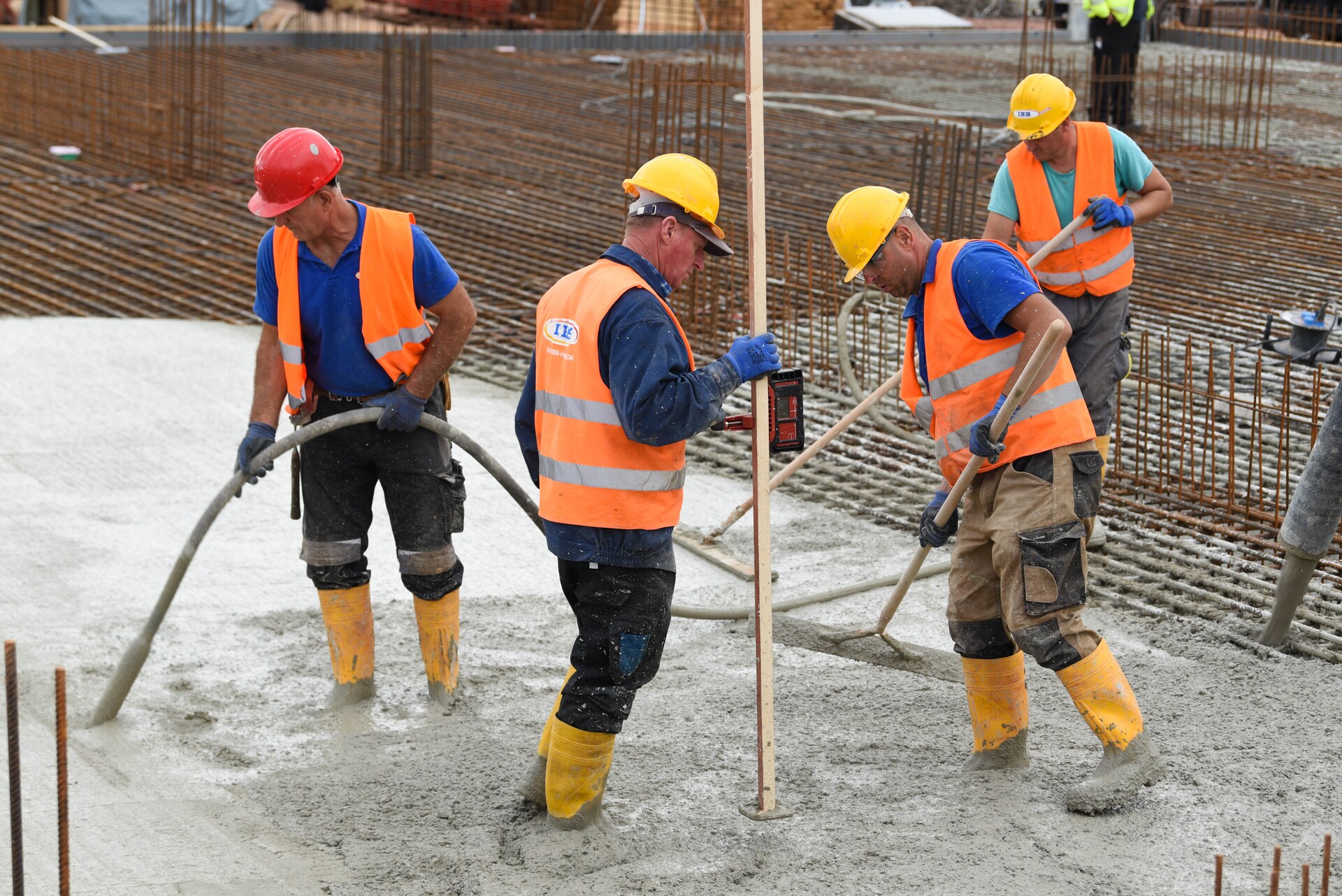 Workers placing and finishing concrete